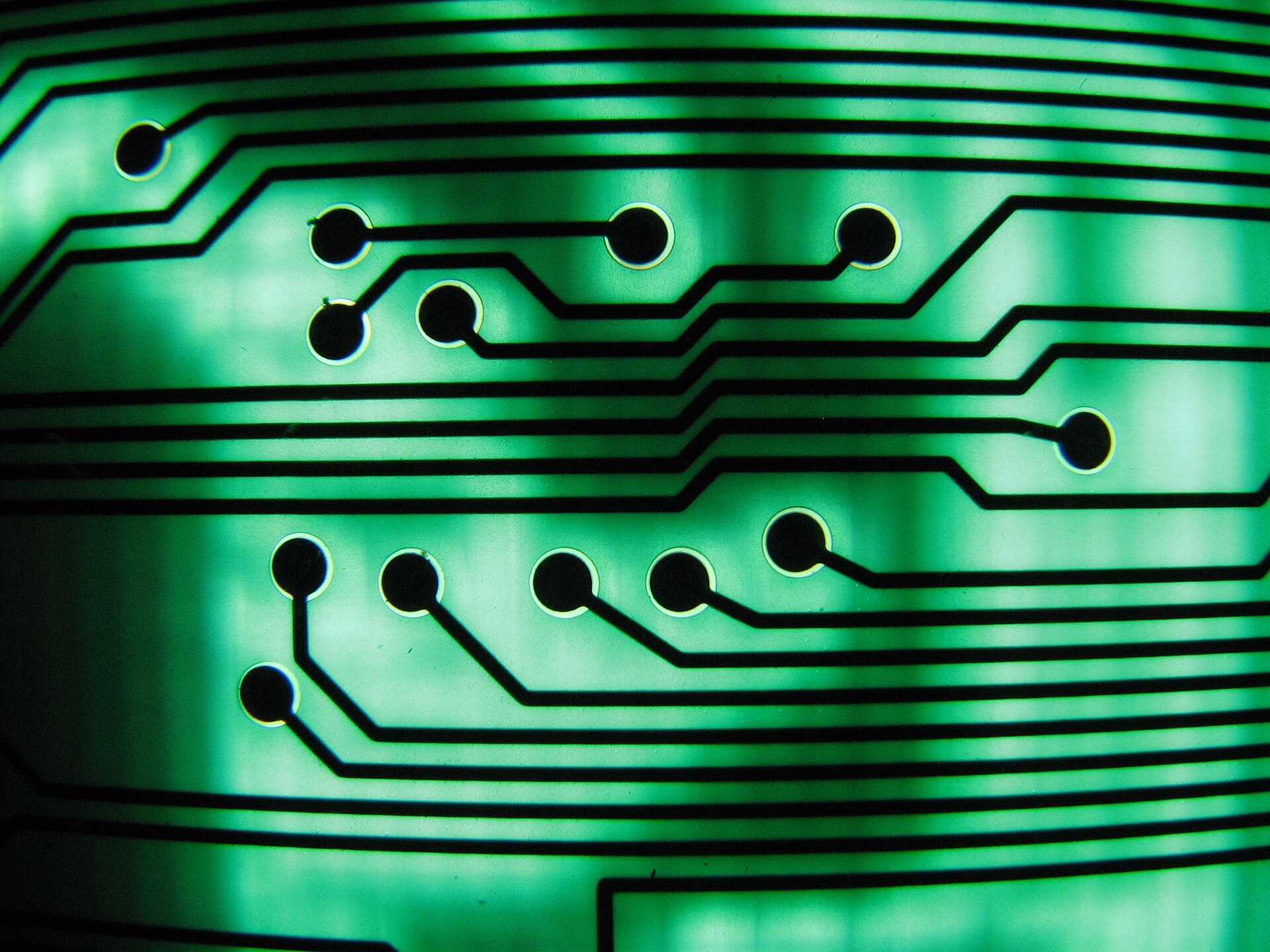 Close-up of a green circuit board with components and traces